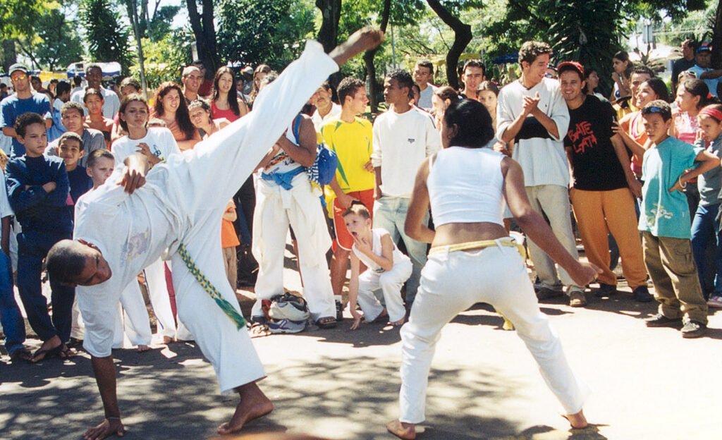 A man and woman taking part in capoeira Brazilian martial arts dance which keeps you fit, improves your body shape and mental health